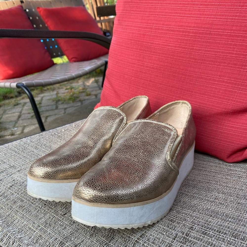 Volatile gold platform shoes.